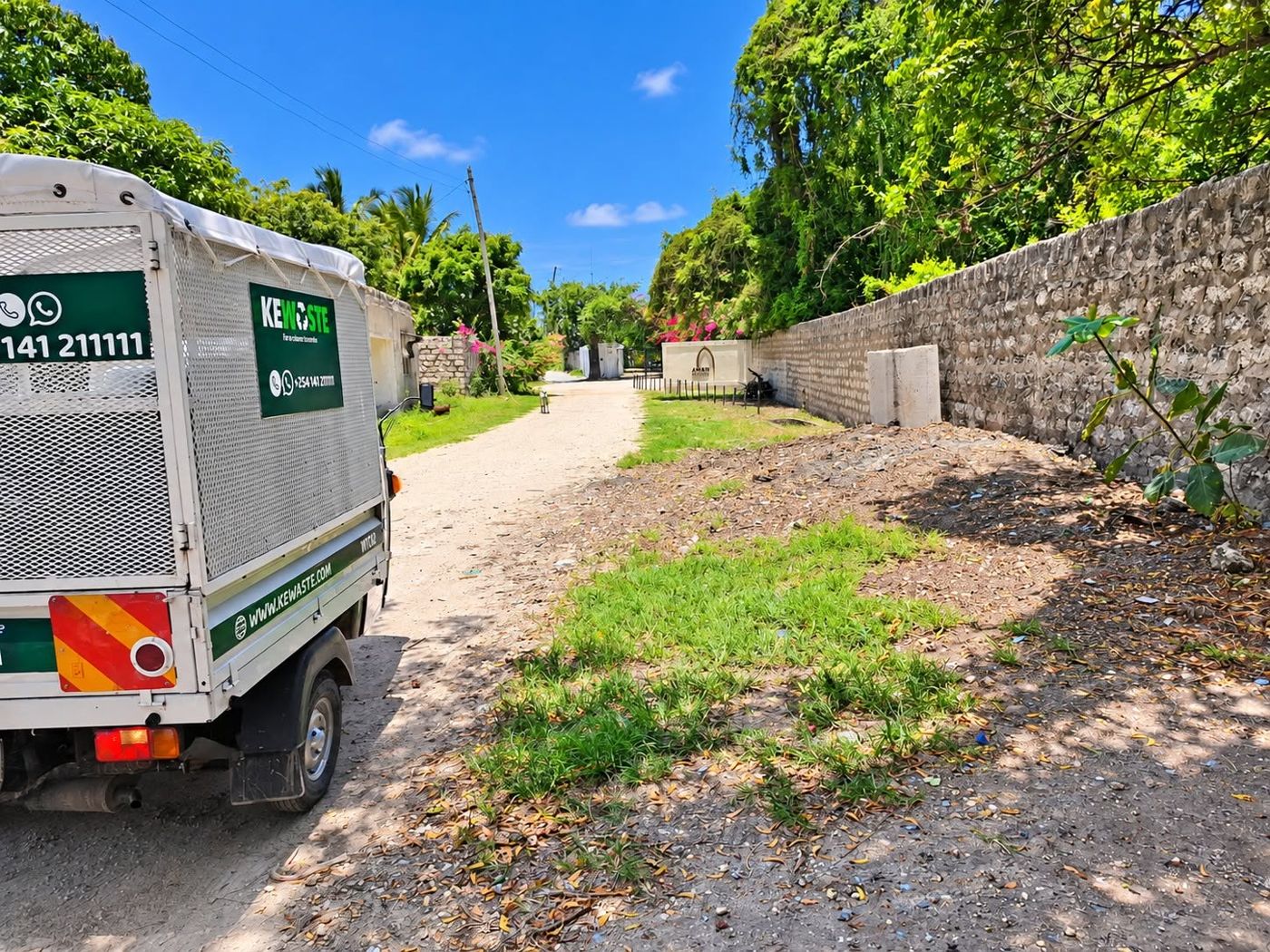 The same road in Watamu after the cleanup, with a KEWASTE tuk-tuk